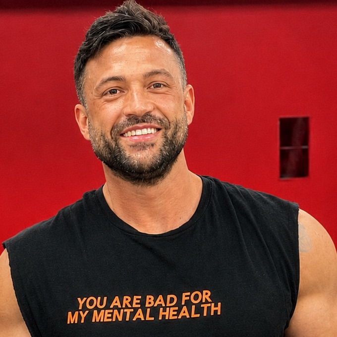 A trainer smiling in the gym